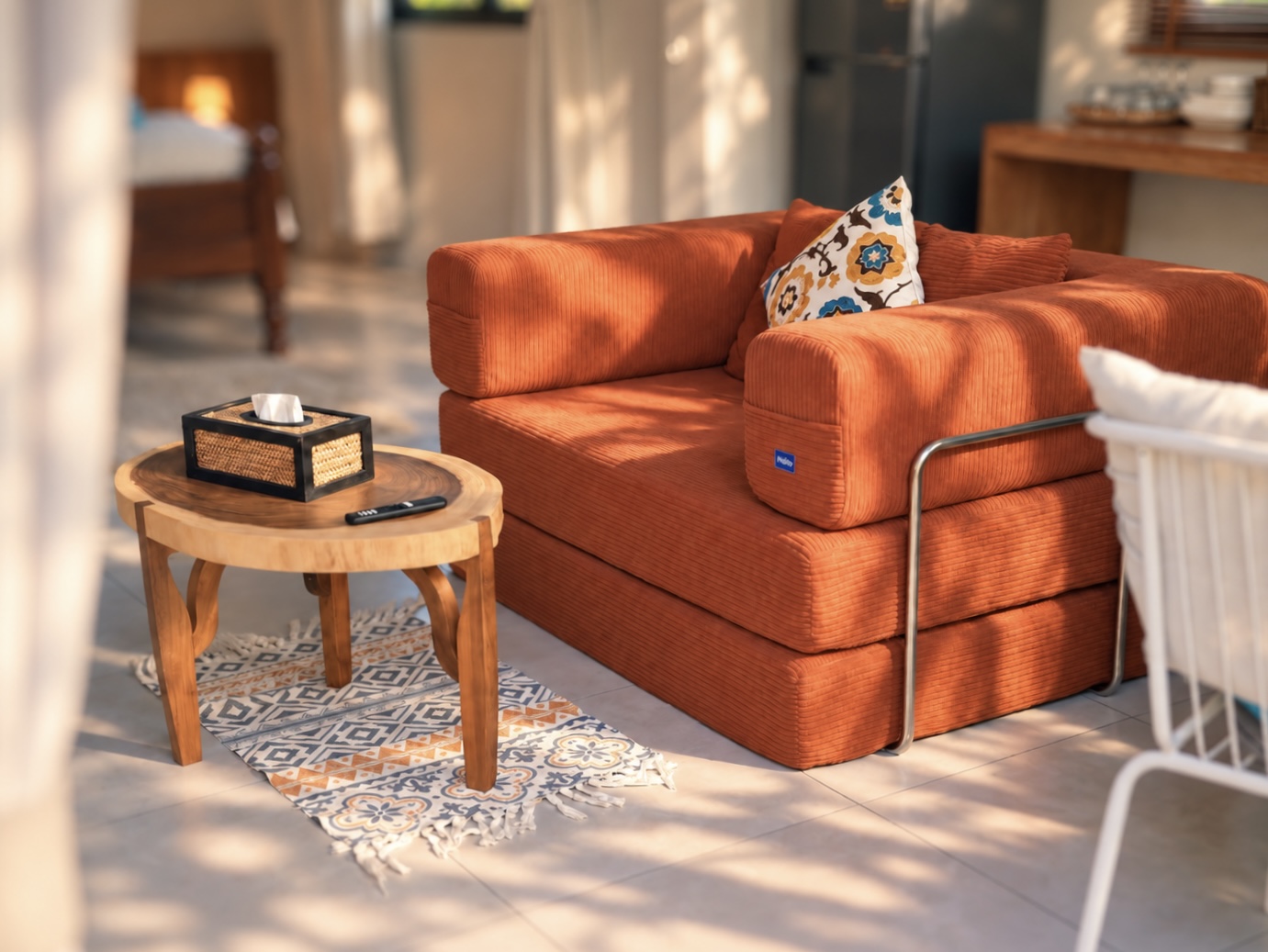 Bungalow B: orange sofa beside a round wooden coffee table